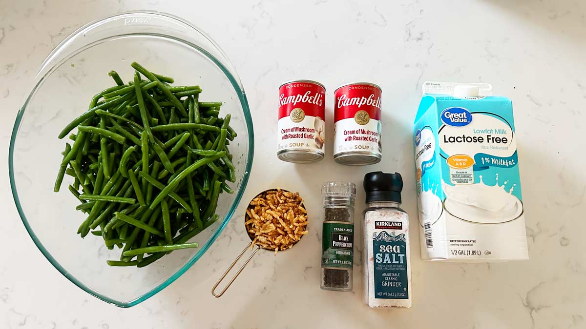 Green Bean Casserole Ingredients; green beans, cream of mushroom soup, crunchy onions, milk, salt and pepper.