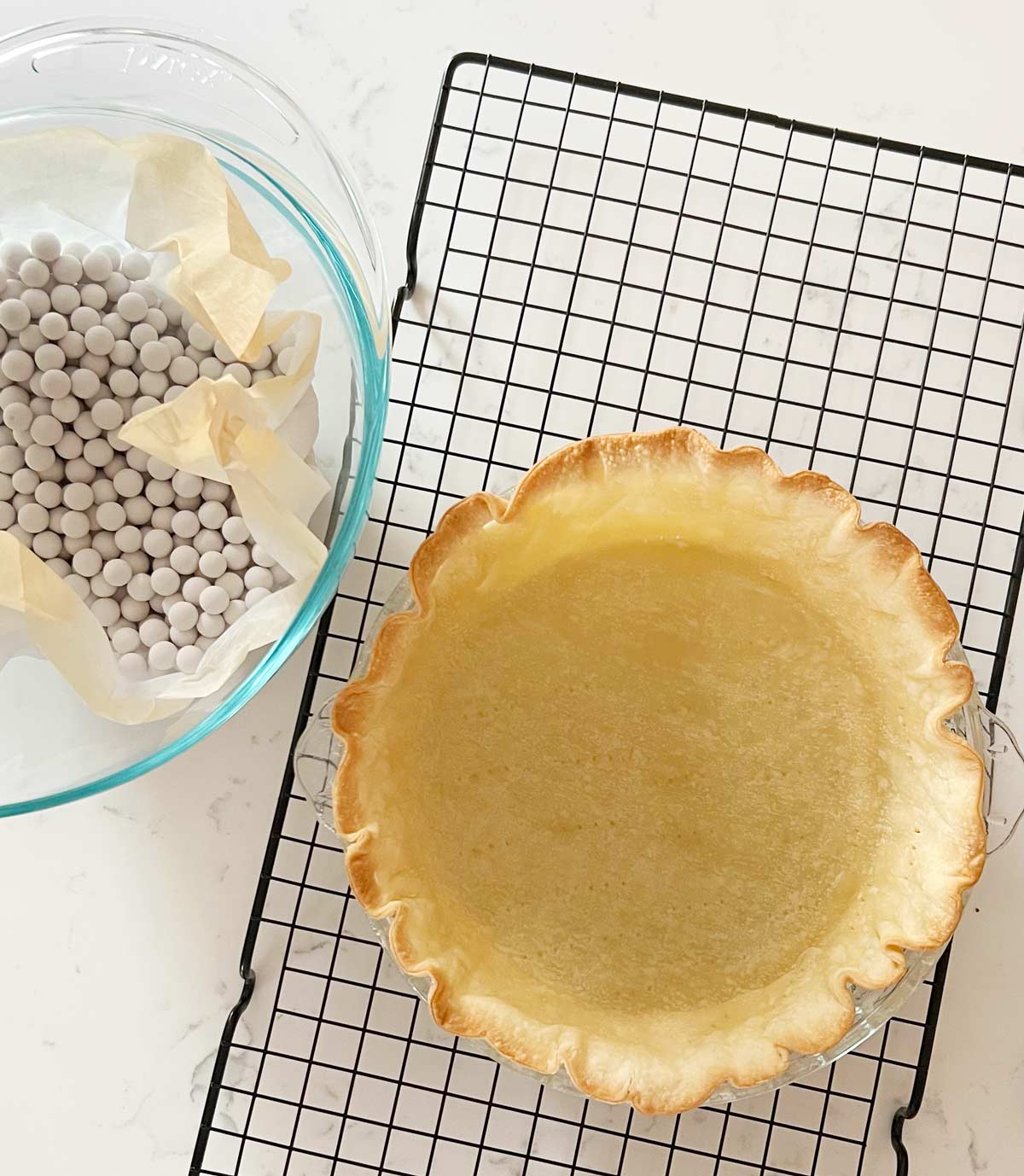 Parbake pie crust on a wire rack with pie weights.